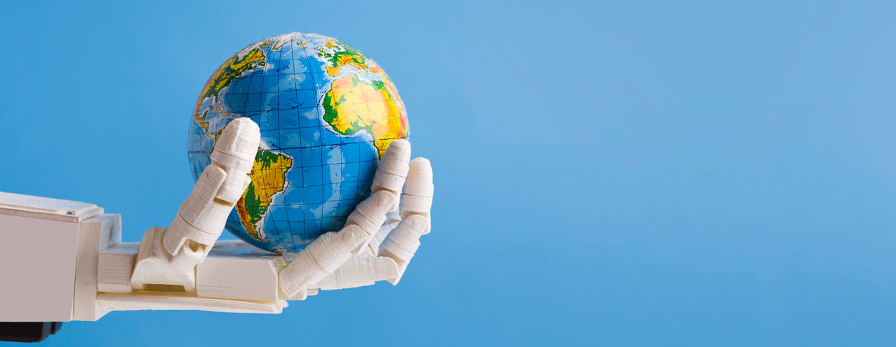 Automatization and artificial intelligence in world. Robot holding Earth globe in hand, blue panorama background with empty space